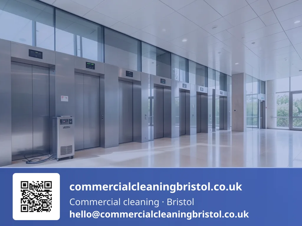 Lobby floor polishing machine buffing a wide expanse of stone tiling near a bank of six elevators