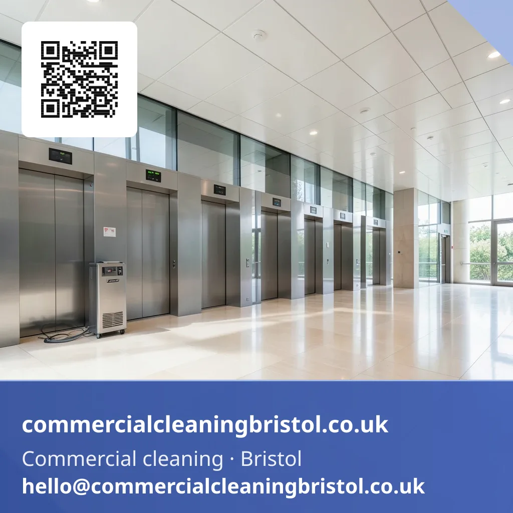 Lobby floor polishing machine buffing a wide expanse of stone tiling near a bank of six elevators