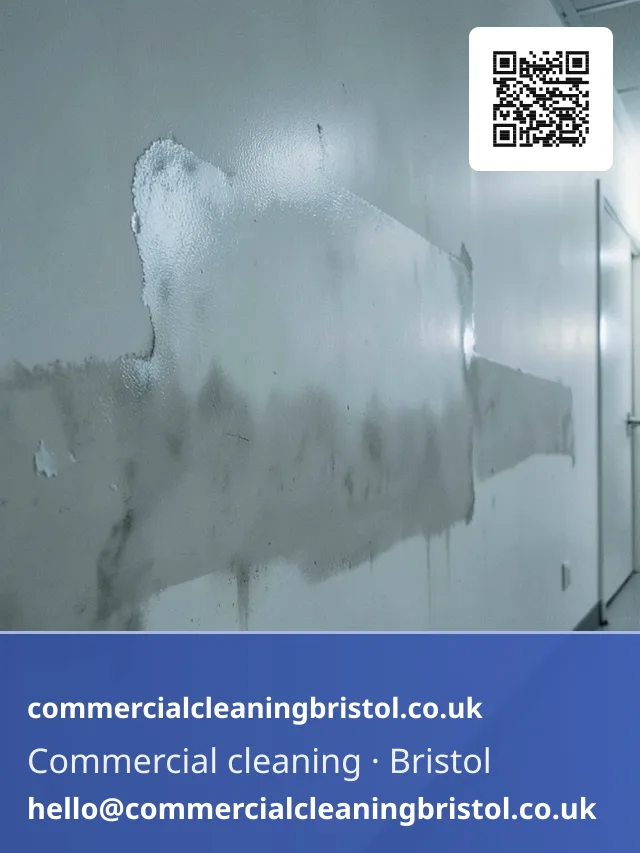 Smoke-damaged corridor wall wiped down section by section with a dry-cleaning sponge