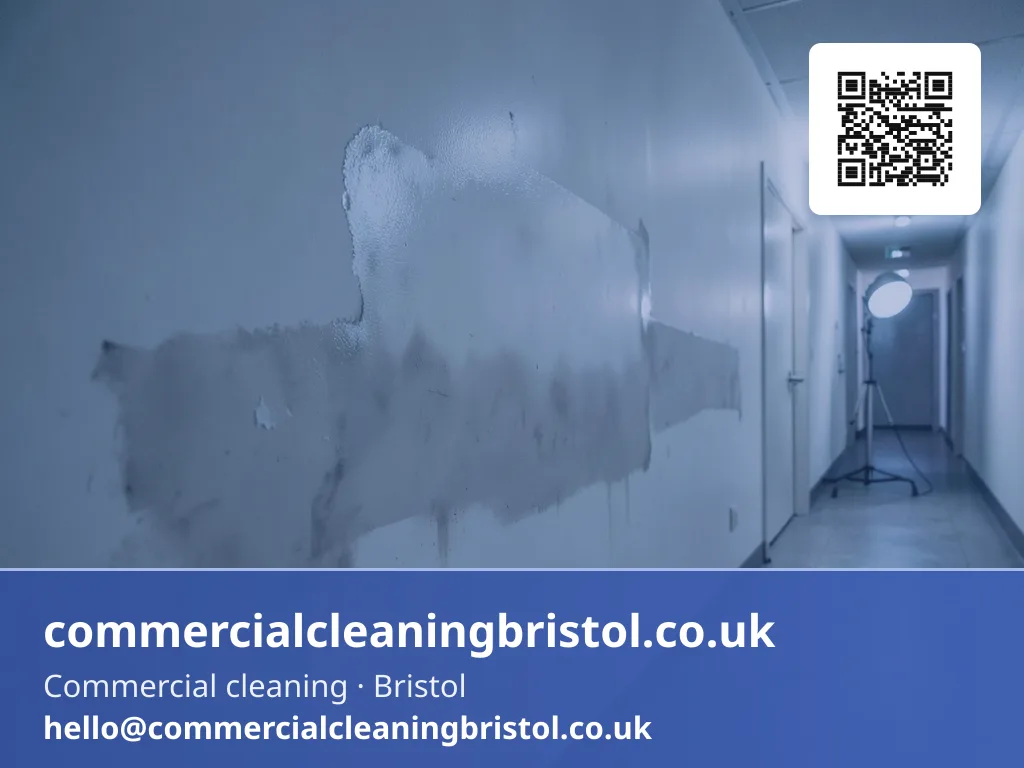 Smoke-damaged corridor wall wiped down section by section with a dry-cleaning sponge
