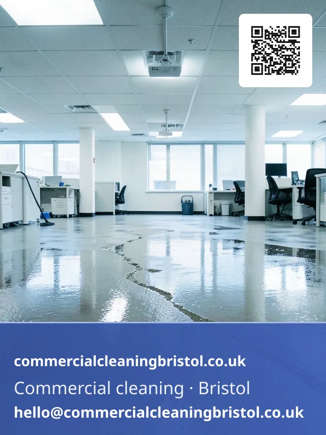 Wet-dry vacuum drawing standing water off an office floor in wide overlapping sweeps