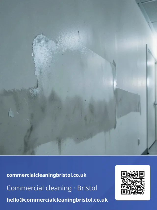 Smoke-damaged corridor wall wiped down section by section with a dry-cleaning sponge