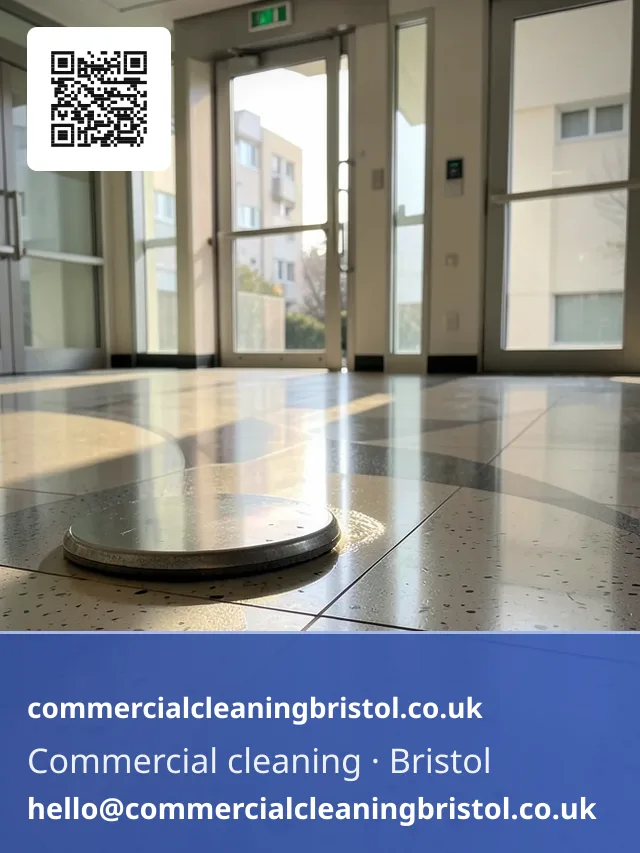 Rotary floor buffer polishing a lobby's terrazzo tiles in overlapping figure-eight passes