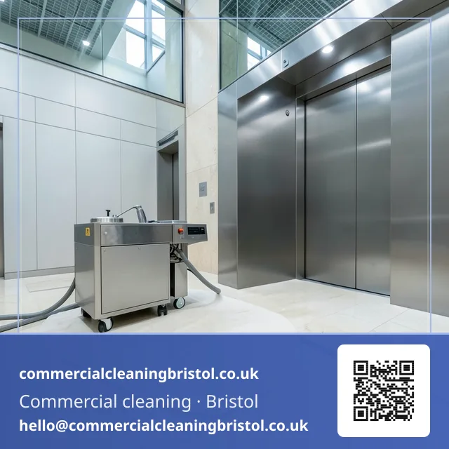 Lobby floor polishing machine's felt pad buffing a wide arc of natural stone tiling near a bank of elevators