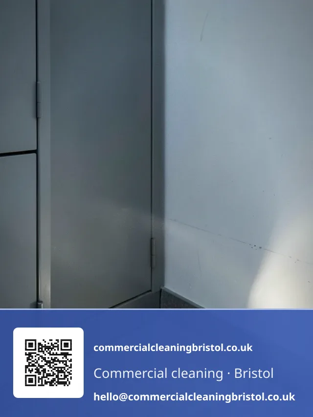 Torch beam sweeping low along a skirting board and into a corner behind a filing cabinet