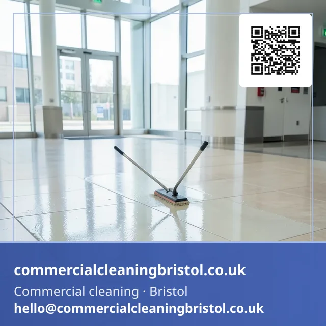 Floor sealant reapplied in a slow even pass across a lobby's stone tiling