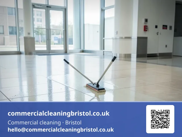 Floor sealant reapplied in a slow even pass across a lobby's stone tiling