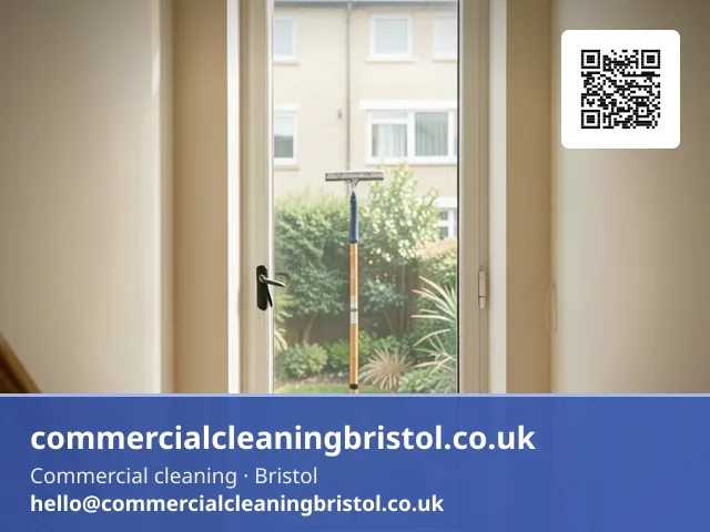 Communal stairwell window cleaned with a squeegee on a short pole