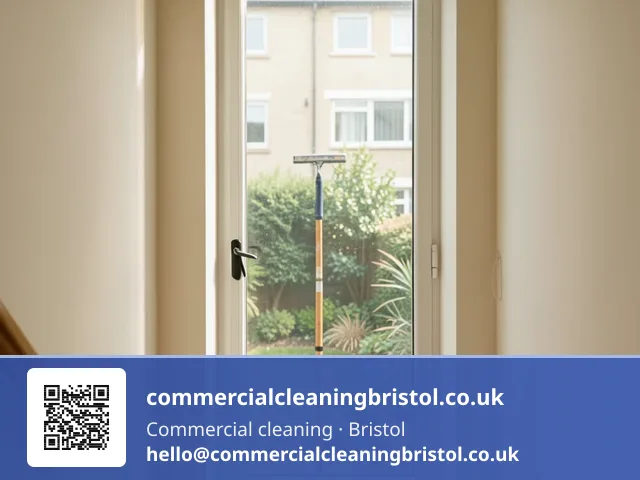 Communal stairwell window cleaned with a squeegee on a short pole