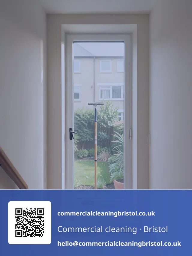 Communal stairwell window cleaned with a squeegee on a short pole