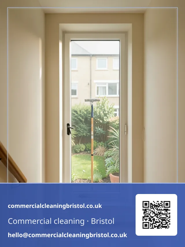 Communal stairwell window cleaned with a squeegee on a short pole