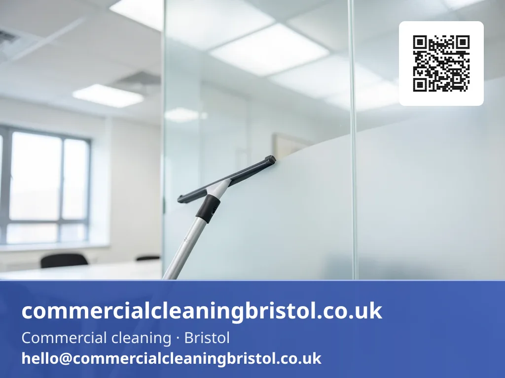 Window squeegee on a short pole wiping a streak-free arc across an internal glazed partition
