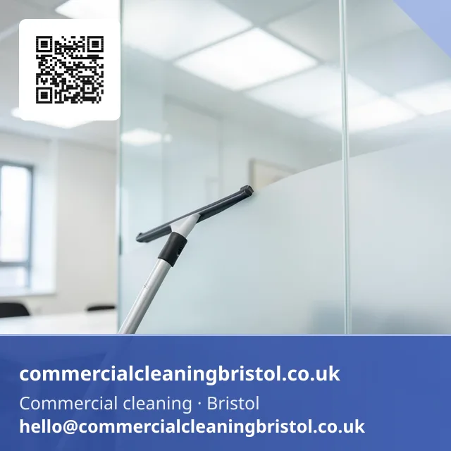 Window squeegee on a short pole wiping a streak-free arc across an internal glazed partition