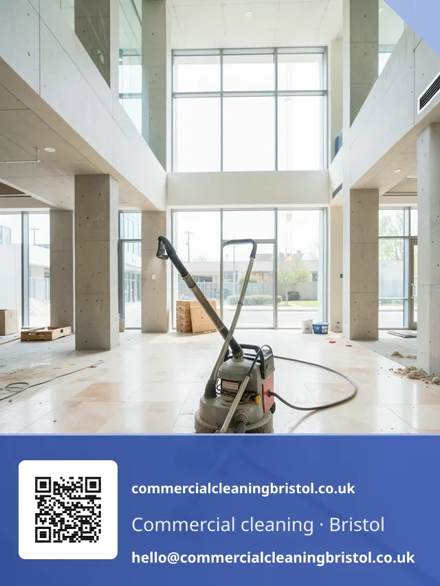 Wide-nozzle vacuum drawing builder's dust from a new-build lobby's stone floor